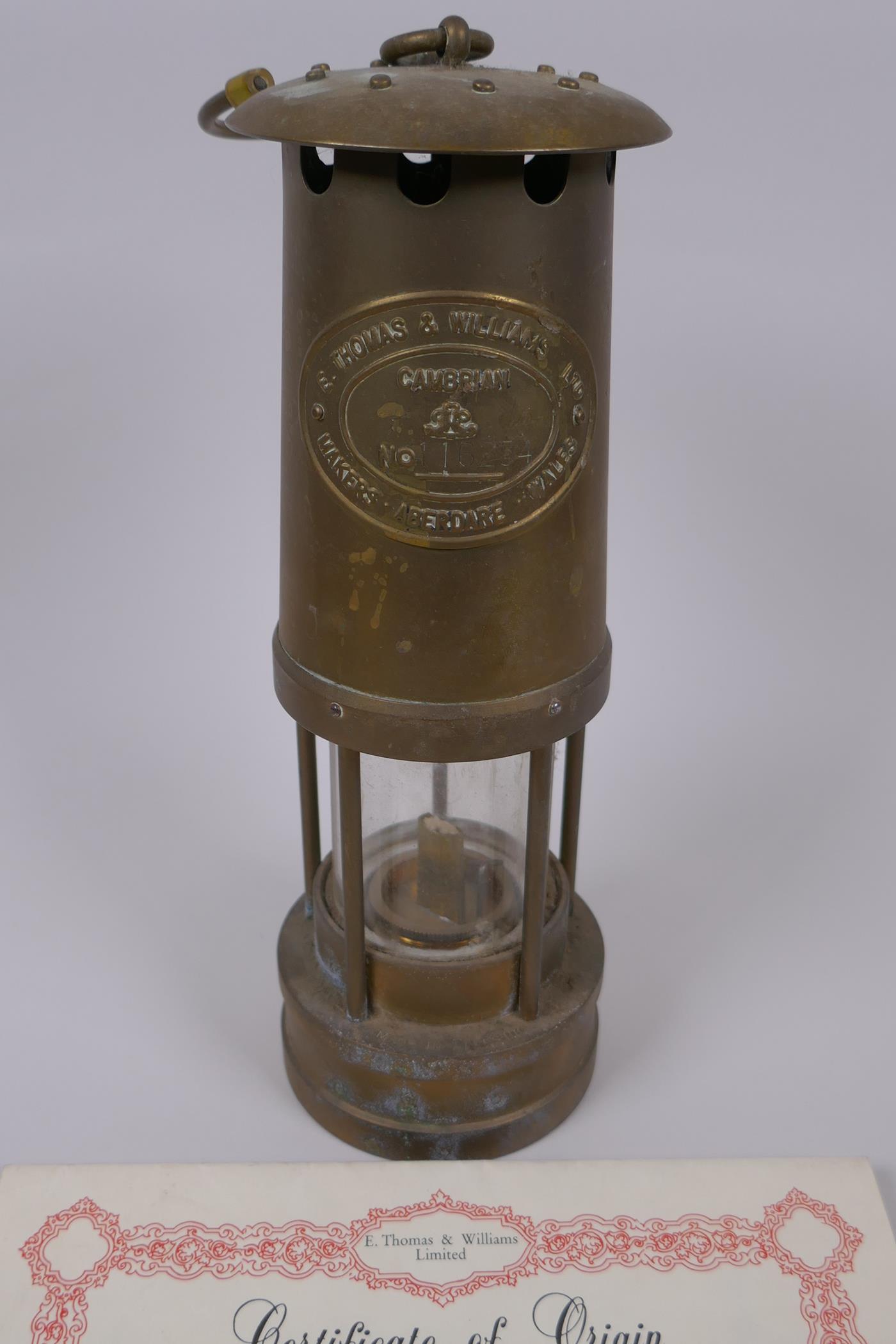 A Cambrian Lampworks brass miner's flame safety lamp by E. Thomas & Williams Ltd, with - Image 2 of 5