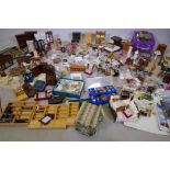 An extensive collection of dolls' house furniture and fittings including carpets, accessories, tea