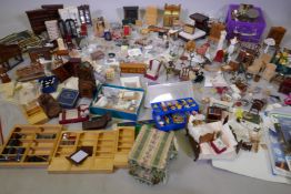 An extensive collection of dolls' house furniture and fittings including carpets, accessories, tea