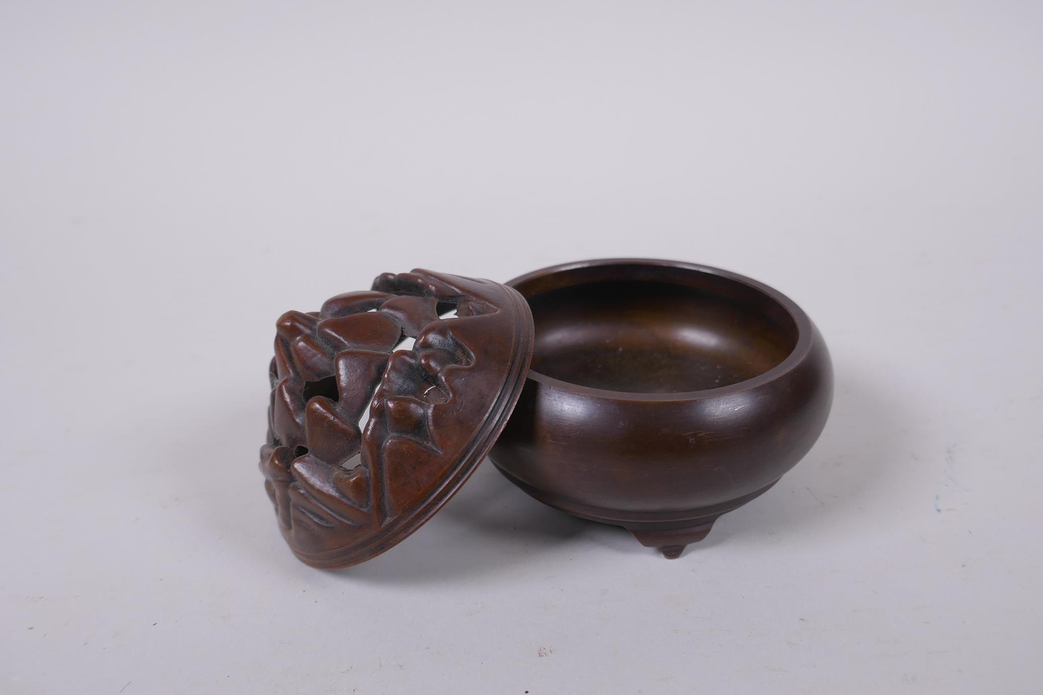 A Chinese bronze censer on tripod supports, the pierced cover in the form of a flame, impressed mark - Image 3 of 4