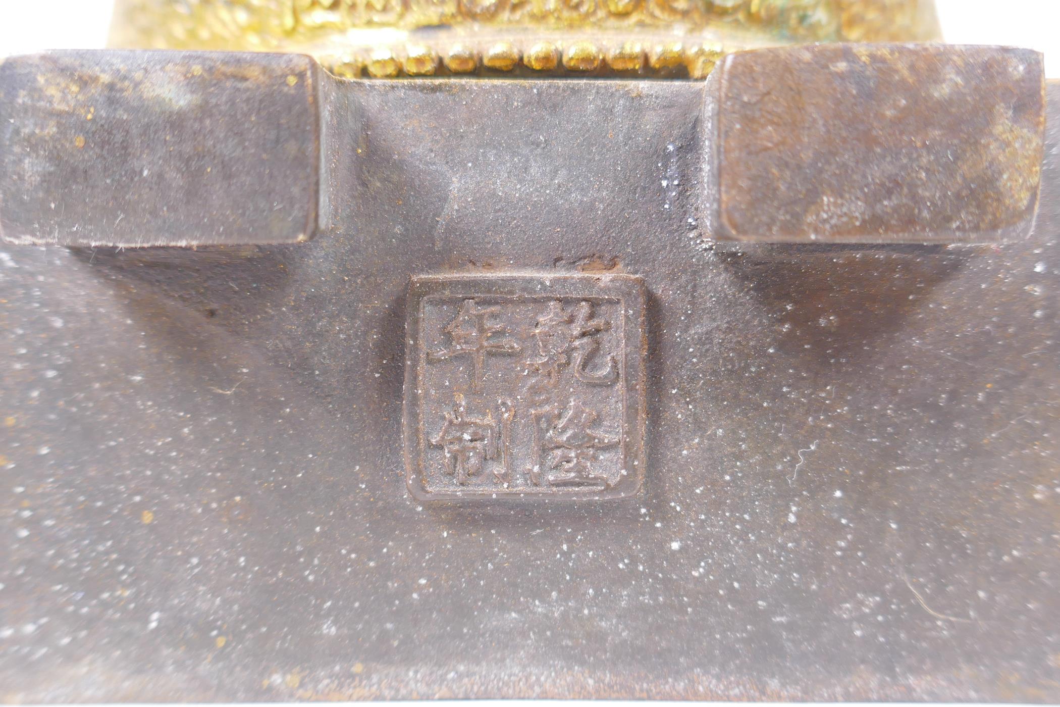 A Sino Tibetan gilt bronze figure of Buddha seated on a dias, Chinese 4 character mark verso - Image 6 of 7