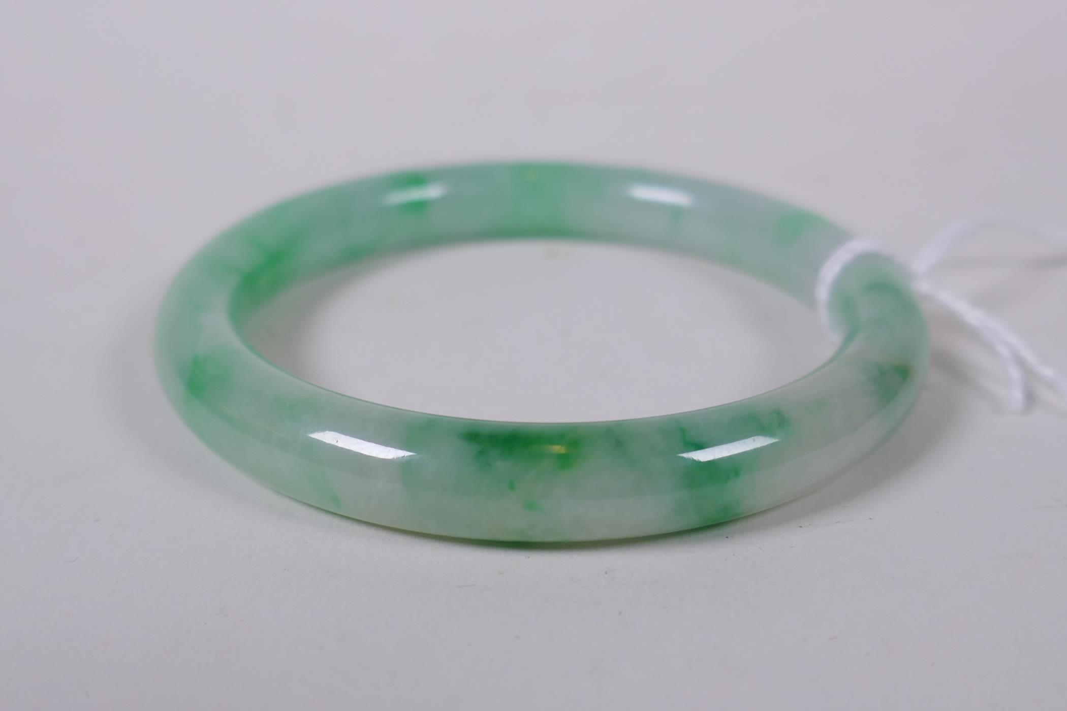 A Chinese mottled nephrite bangle, 5.5cm interior diameter - Image 2 of 2