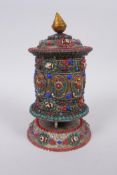 A Tibetan white metal prayer wheel with painted details, set with agate eye beads, turquoise etc,