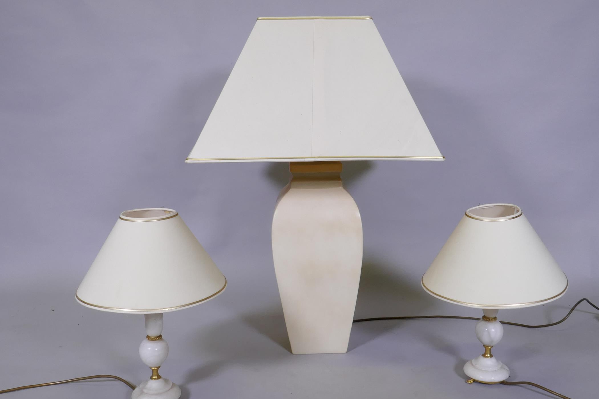 A ceramic table lamp and a pair of smaller alabaster lamps, 78cm with shade