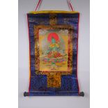 A Tibetan printed Thangka with gilt details, on a silk scroll mount, 49 x 62cm