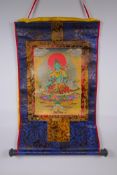 A Tibetan printed Thangka with gilt details, on a silk scroll mount, 49 x 62cm