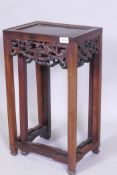 A nest of two Chinese hardwood tables, with carved and pierced dragon frieze, square supports and