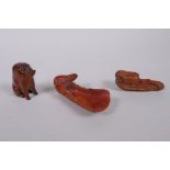 Two Japanese carved boxwood netsuke in the form of rats on a corn husk and a warthog, together