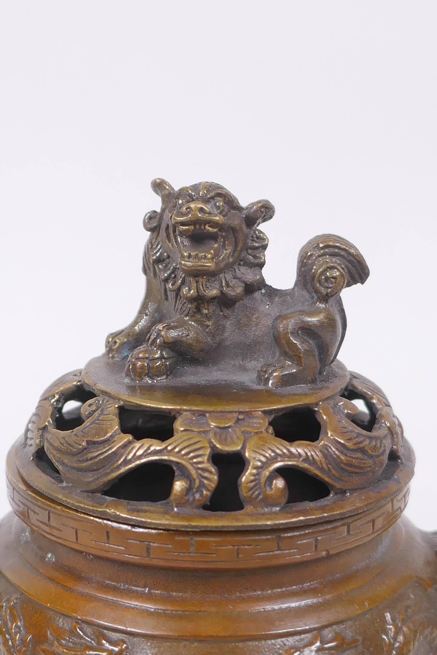 A Chinese bronze two handled censer and cover raised on tripod supports with raised dragon - Image 2 of 5