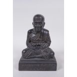 A Tibetan filled bronze Buddha, inscription to front, 19cm high