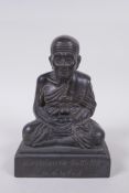 A Tibetan filled bronze Buddha, inscription to front, 19cm high