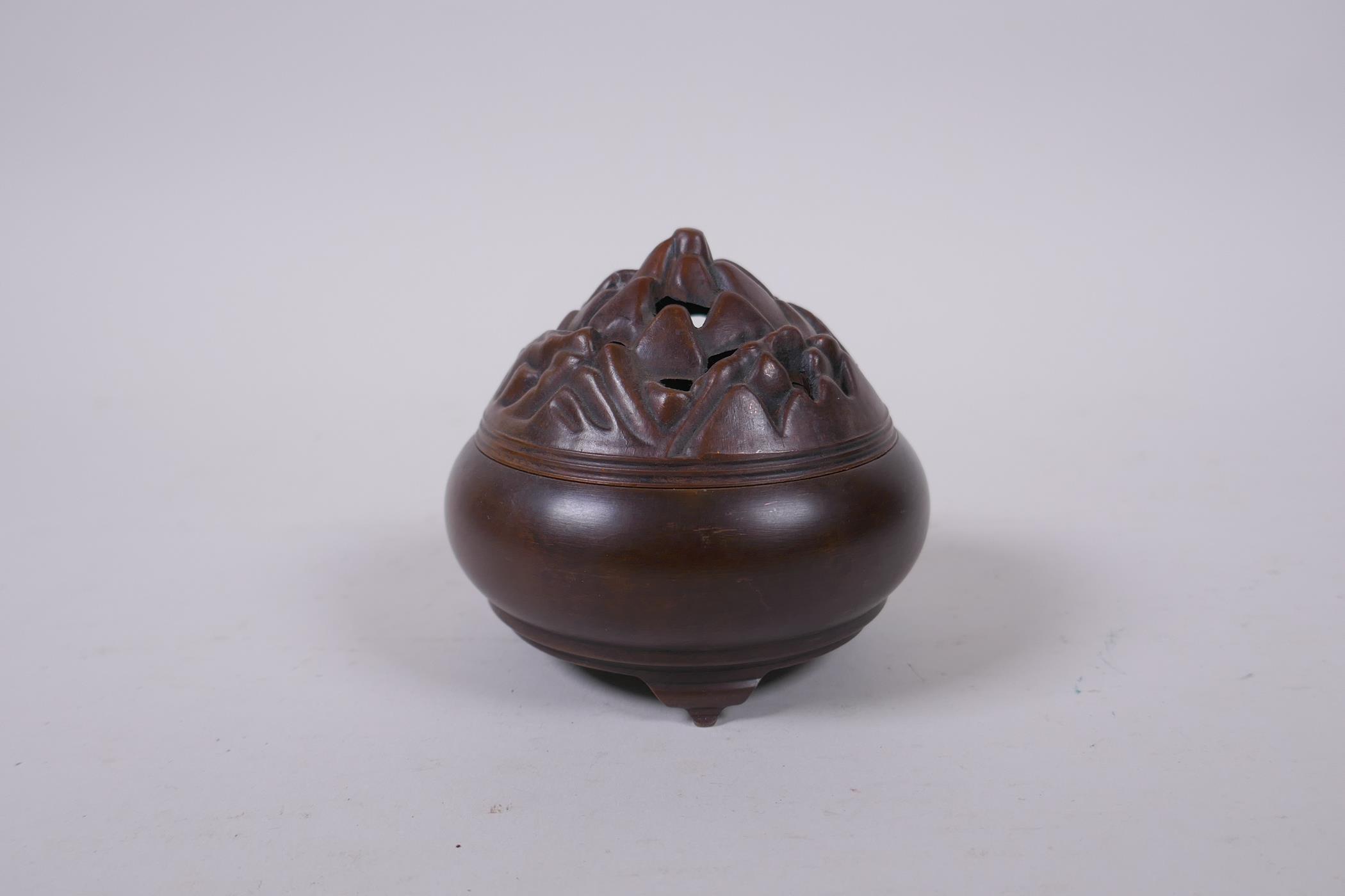 A Chinese bronze censer on tripod supports, the pierced cover in the form of a flame, impressed mark - Image 2 of 4