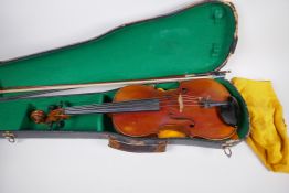 A vintage violin with two piece back and ebony pegs, with a bow and hard carry case, 60cm long