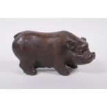 A Chinese filled bronze figure of a sow, impressed seal mark to base, 18cm long
