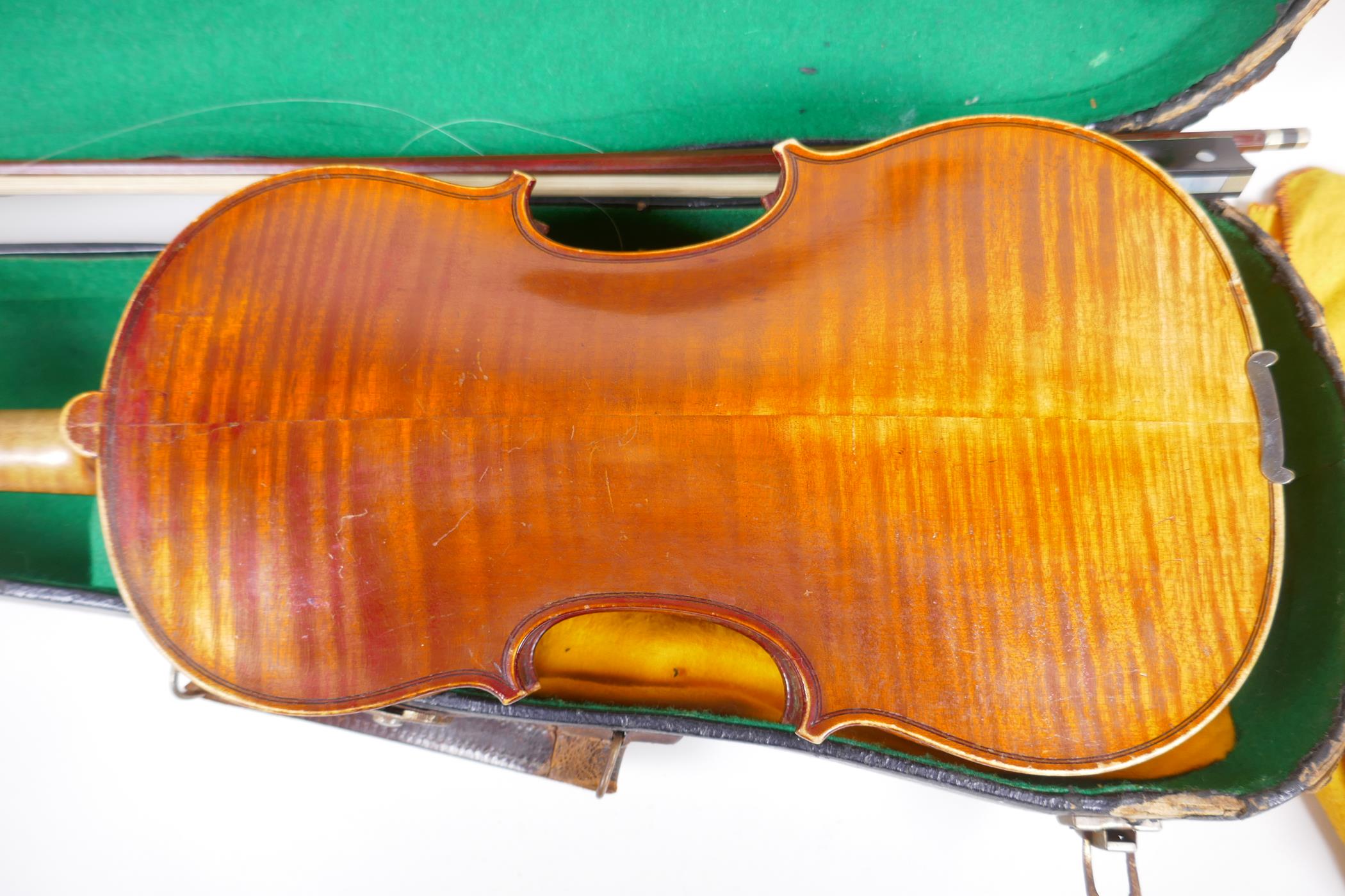 A vintage violin with two piece back and ebony pegs, with a bow and hard carry case, 60cm long - Image 3 of 7