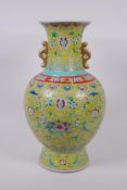 A Chinese famille jaune porcelain vase with two handles, decorated with bats, lotus flowers,