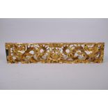 A Chinese carved and giltwood panel decorated with two dragons and a pearl, 60 x 12cm, 5cm high