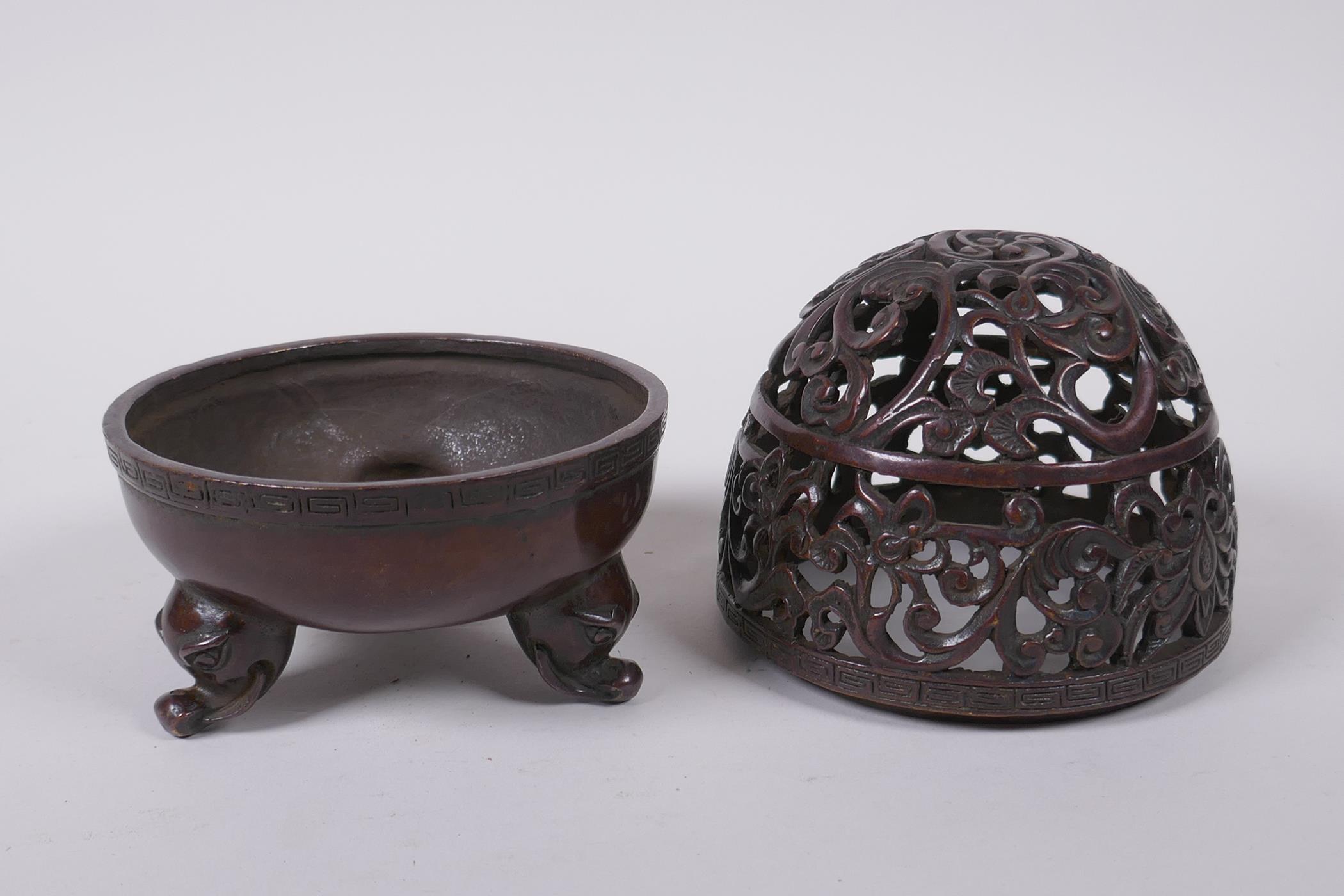 A Chinese bronze censer and pierced cover with tripod supports and scrolling floral decoration, 4 - Image 4 of 5