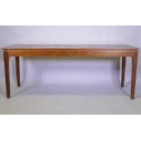 A mid century oak veneered serving table, raised on square tapering supports with pegged joints,