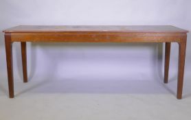 A mid century oak veneered serving table, raised on square tapering supports with pegged joints,