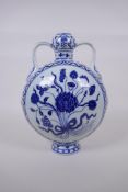 A blue and white porcelain moon flask with garlic head shaped neck and two handles, decorated with a