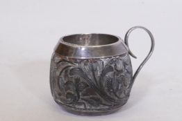 An C18th/C19th carved coconut cup with silver mounts, 4.5cm high