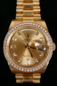 A gentleman's 18ct gold Rolex Oyster Perpetual Day-Date wrist watch with a diamond set bezel and