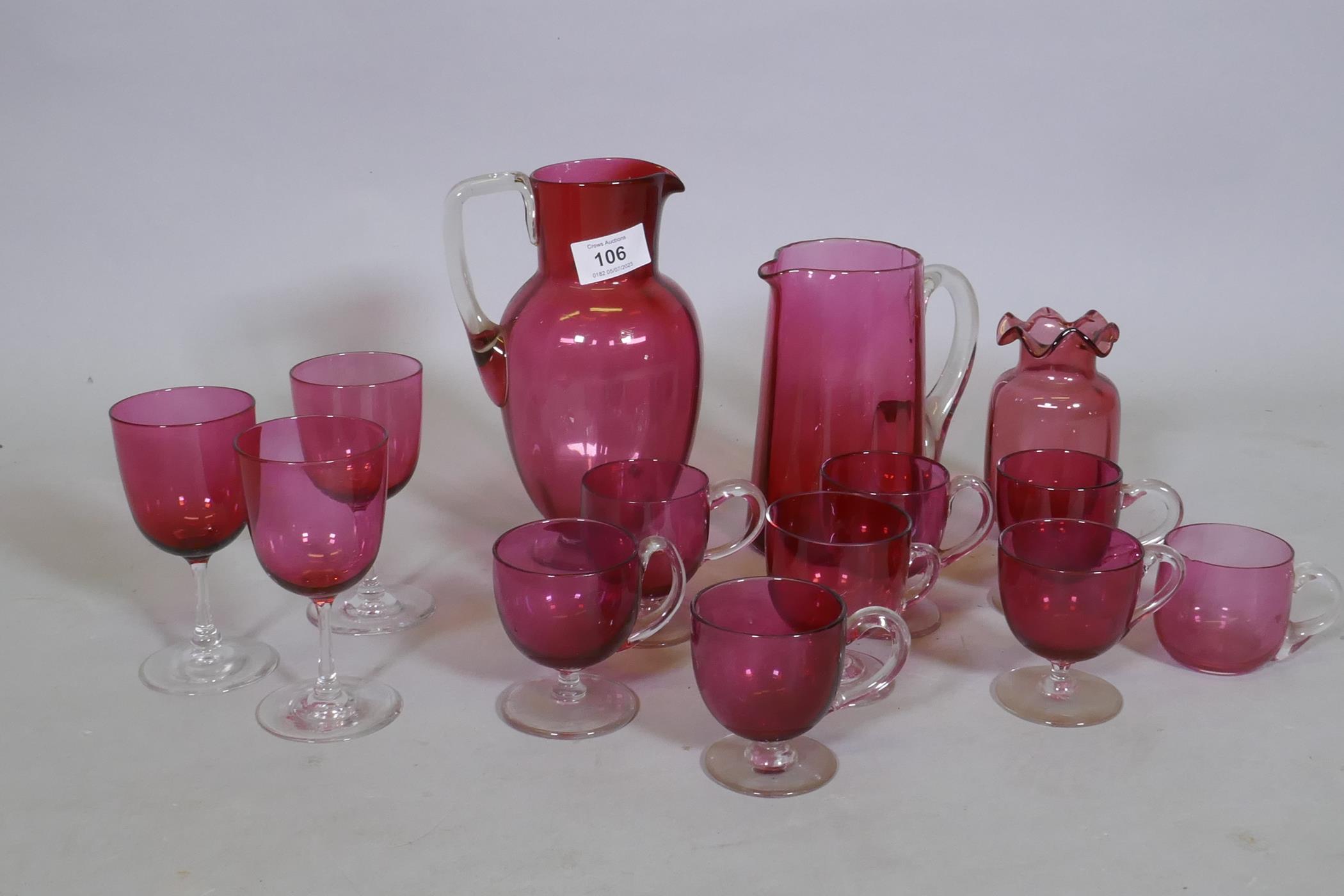 A quantity of Victorian cranberry glass, jugs, drinking glasses and custard cups