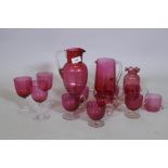 A quantity of Victorian cranberry glass, jugs, drinking glasses and custard cups