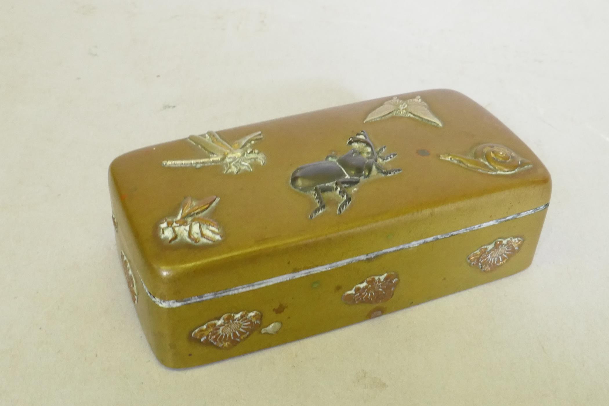 A Japanese Meiji period brass stamp box with raised multi-metal decoration of beetles, dragonfly and