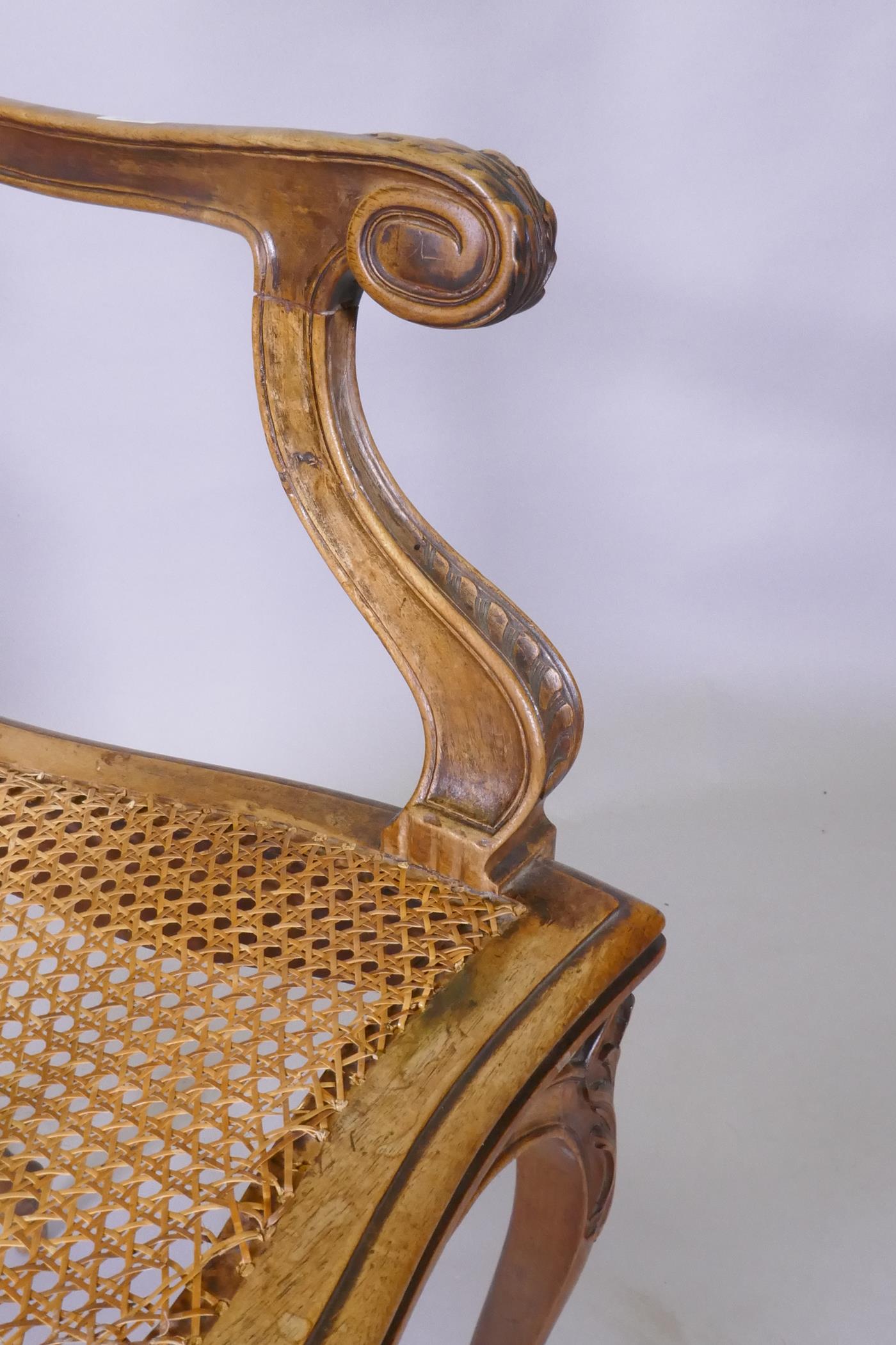 A C19th French carved walnut open arm chair with caned seat - Image 5 of 5
