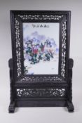 A Chinese famille verte porcelain panel depicting figures in a riverside landscape with distant