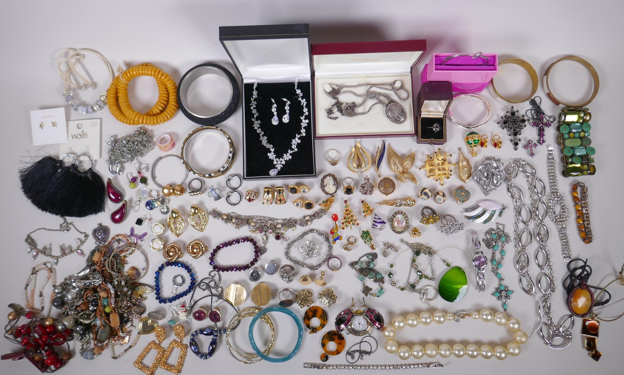 An assortment of vintage costume jewellery including bangles, necklaces, earrings, rings etc