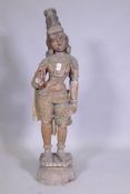 An Indian carved and painted wood Buddhistic figure, 95cm high