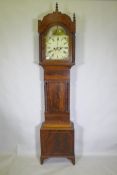 C19th mahogany long case clock, with arched hood and painted dial, the spandrels decorated with