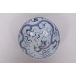 A Chinese blue and white porcelain conical bowl decorated with a dragon highlighted with red, 6