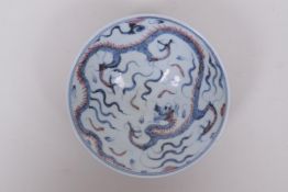 A Chinese blue and white porcelain conical bowl decorated with a dragon highlighted with red, 6