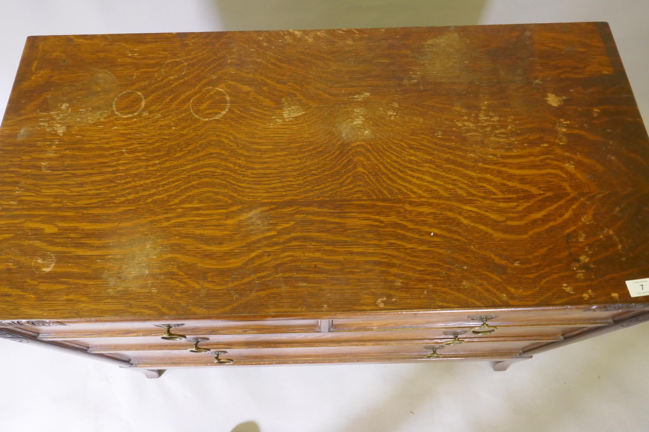 An Arts & Crafts oak chest of two over two drawers, with carved decoration and brass handles, raised - Image 5 of 5