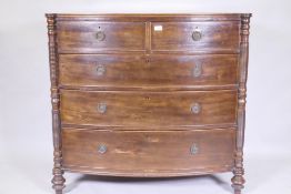 A good Regency mahogany bowfront chest of four long drawers, with cockbeaded detail and brass ring
