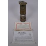 A Cambrian Lampworks brass miner's flame safety lamp by E. Thomas & Williams Ltd, with