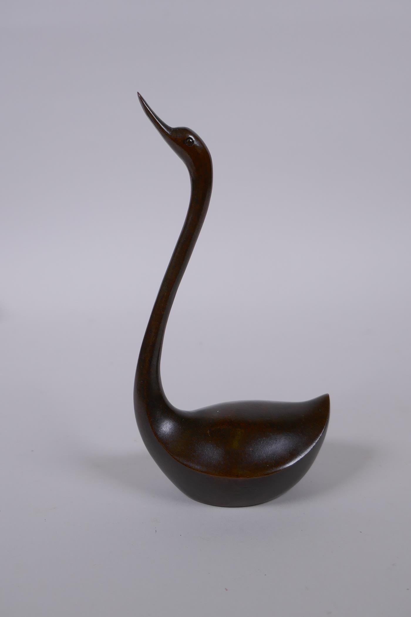 A Japanese style bronze okimono swan, mark to base, 15cm high