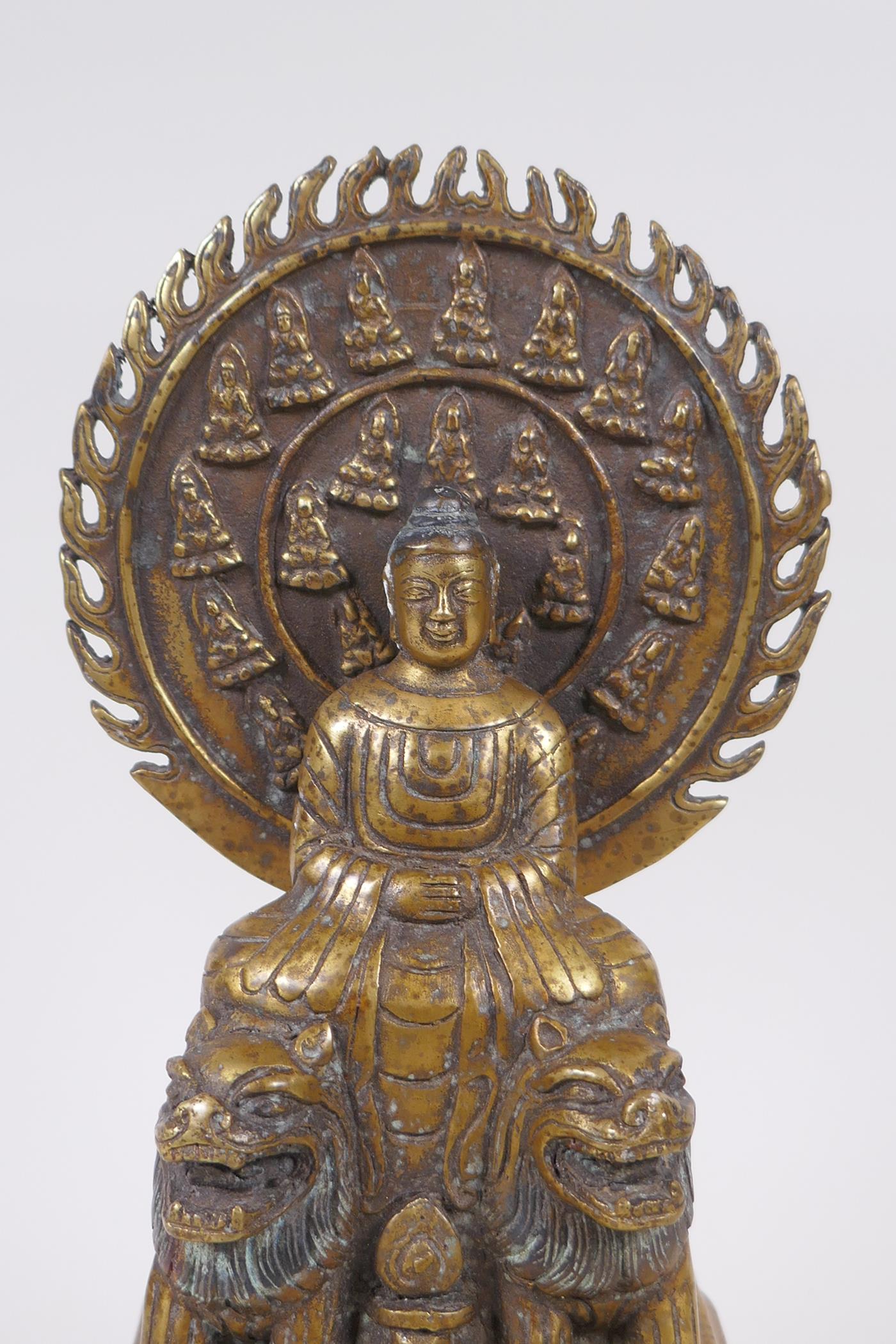 A Sino Tibetan bronze Buddha seated on Fo-dogs, standing on a disc, character inscription verso, - Image 2 of 5