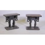 A pair of antique African carved wood stools, raised on elephant supports, 46 x 27 x 44cm