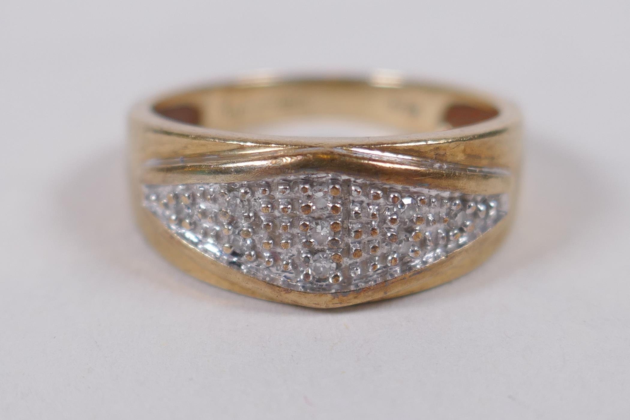 A 9ct yellow gold ring set with nine diamond chips, size K/L