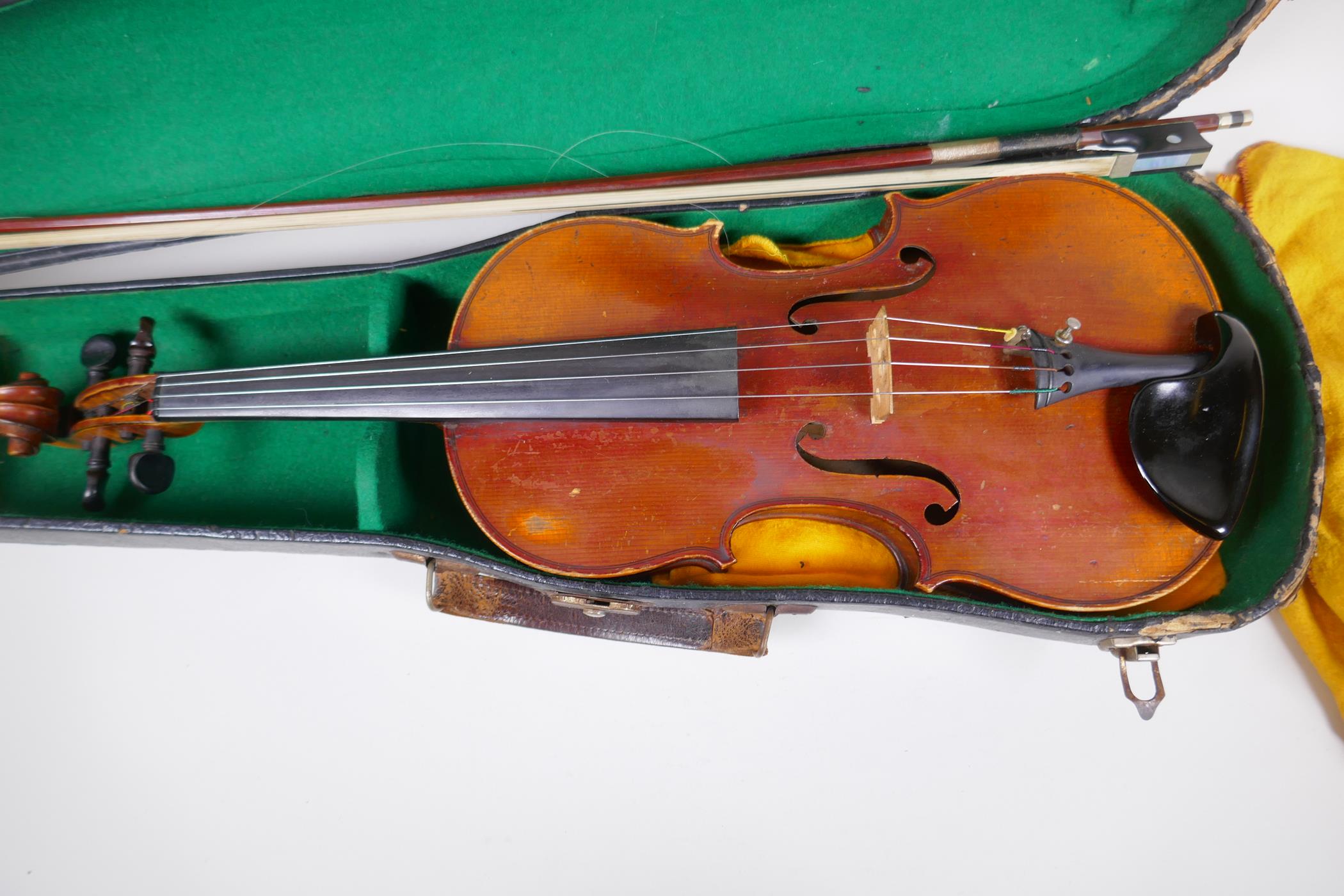 A vintage violin with two piece back and ebony pegs, with a bow and hard carry case, 60cm long - Image 2 of 7