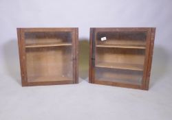 A pair of oak hanging cabinets with glazed doors and adjustable shelves, 49 x 49 x 20cm