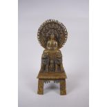 A Sino Tibetan bronze Buddha seated on Fo-dogs, standing on a disc, character inscription verso,