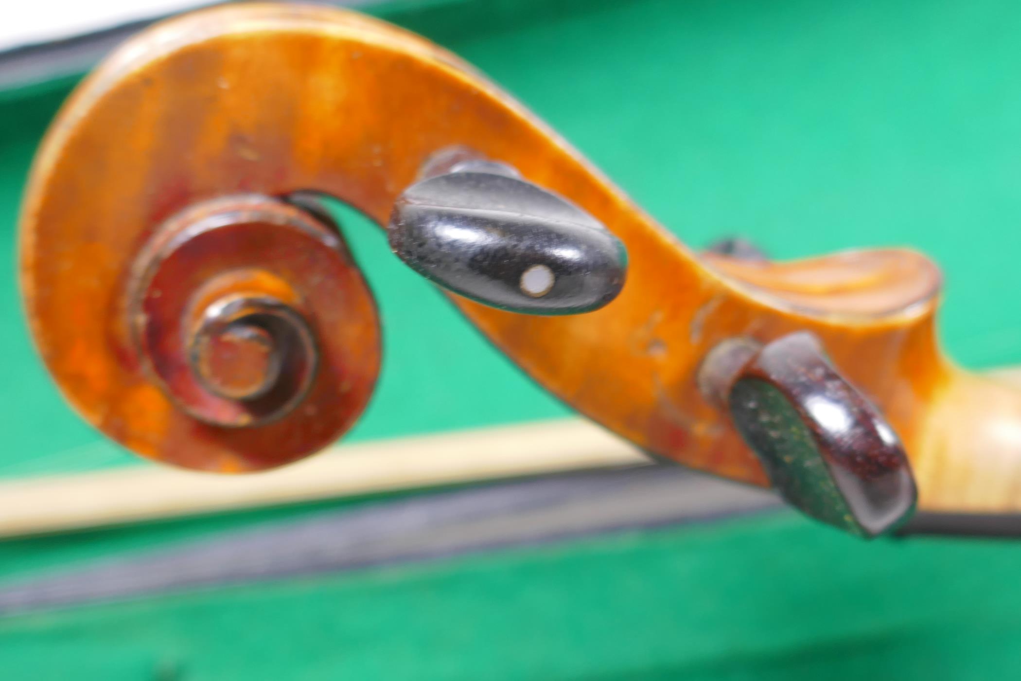 A vintage violin with two piece back and ebony pegs, with a bow and hard carry case, 60cm long - Image 5 of 7