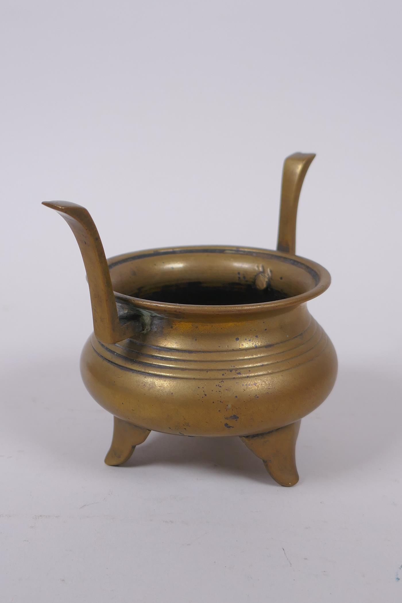 A Chinese bronze two handled censer on tripod supports, 9cm high - Image 2 of 3