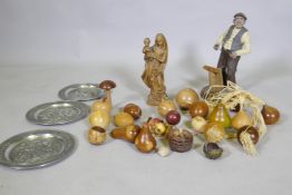 A collection of treen wood carvings of fruit, a composition model of a wood worker and a carved